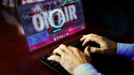 Man typing on the keyboard with On Air on screen on desk. Broadcast, media live stream, home blogger, youtuber, influencer and online broadcasting abstract concept. Hand shake camera.