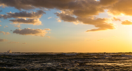 Cloudy sunset at the stormy sea.