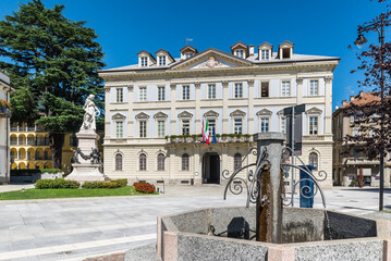Naklejka premium Beautiful square in an old city in Europe. Domodossola, ancient city in northern Italy, historic center with the Palazzo di Città, as written above the entrance, (year 1847), seat of the town hall 