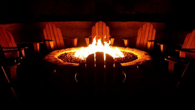 Chairs arranged around a cozy backyard fire pit.