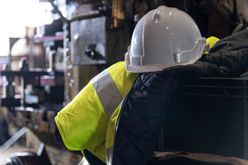 protect safety helmet and safety Vest put on engineering machine in industrial factory