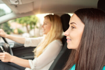 Two girls are traveling by car.