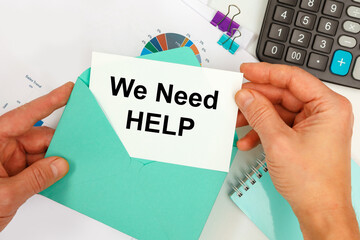The businessman takes out a card from the envelope with the text We Need Help