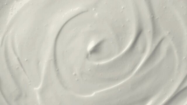 Sour cream, Greek yogurt texture. White dairy product swirl closeup