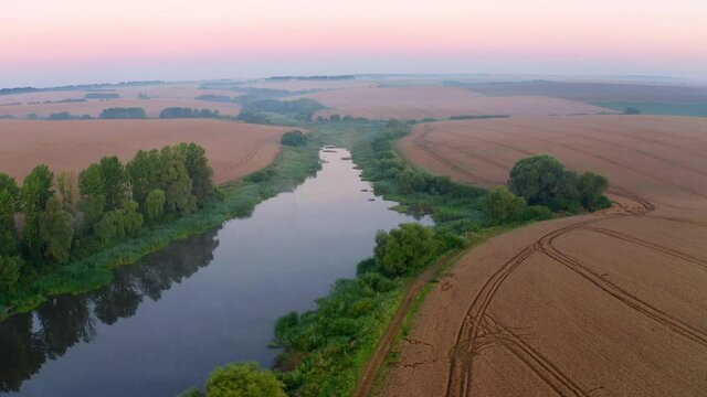 4k drone flight moving to the side footage (Ultra High Definition). Misty summer sunrise on Ternopil outskirts with small river. Spectacular morning view of hte Ukrainian countryside.