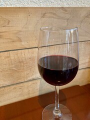 glass of red wine on wooden table