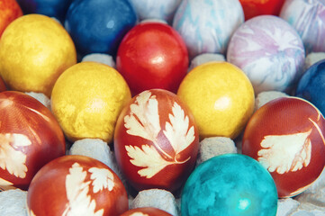 Fototapeta na wymiar Background of colored Easter eggs. Colored eggs are placed in cells on the table. Horizontal background for Easter greetings