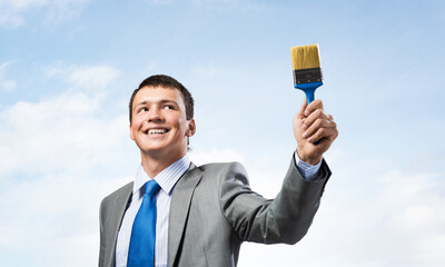 Creative businessman painter holding paintbrush