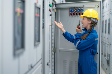 A female electrical engineer feeling unhappy during inspecting work in the electrical control room ,Industrial quality work business concept