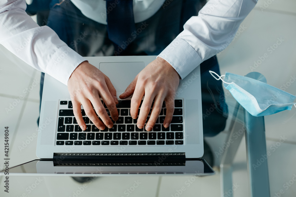 Wall mural business man typing on a laptop keyboard.