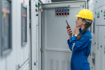 A female electrical engineer inspecting work in the electrical control room ,Industrial quality work business concept
