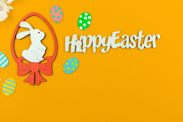 Cute bunny with colorful easter eggs over the yellow background
