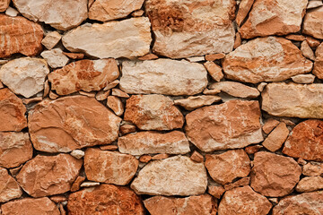 texture of a old red stone wall mediterrranean spain architecture, wall background