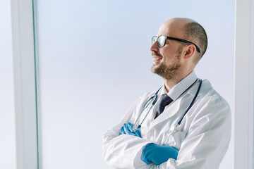 smiling doctor with a stethoscope looking ahead.