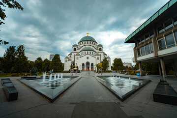 Fototapeta na wymiar Low angle view of Temple of Saint Sava with fountain in foreground in Belgrade city