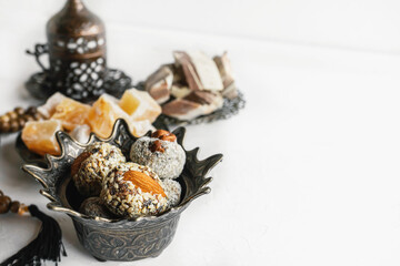 bowl with various pieces of Turkish delight and Oriental sweets on a light background. copy space