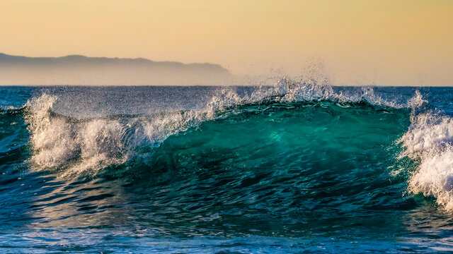 Early morning waved at sunrise in Victoria Bay, Western Cape