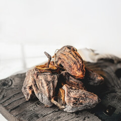 Dried persimmons on a wooden board. Dehydrated fruit. copy space