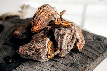 Dried persimmons on a wooden board. Dehydrated fruit