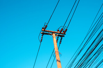 Electricity pole against blue sky clouds, Transmission line of electricity to rural distribution