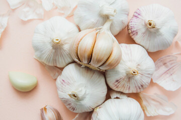 Garlic bulbs on pink background, close-up. Organic garlic top view. Food background. Selective focus.