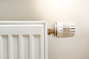 Thermostatic head and radiator valve. Close-up view. Energy saving and save money concept with copy space. Reduce consumption of gas or electricity.