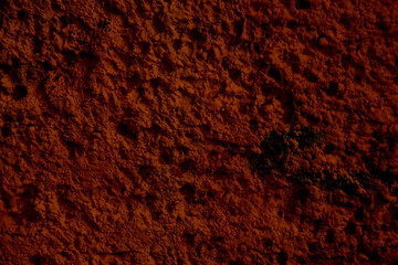 texture of a dark red wall covered with with torn old paper and plaster, style grunge, space for text, space for cop