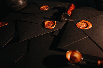 black postage envelopes with wax sea lthe envelope