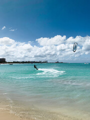 Tropical island. Caribbean beach. Windsurfer sailing in the ocean, aquatic sport
