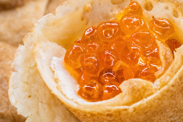 Homemade pancakes with red caviar.