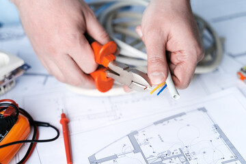 Man,repairer making electricity project in house.Repairs planning.Drawings,diagrams,plan for...