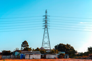 High voltage electricity pole on bright sky clouds, Electricity transmission pylon among the city
