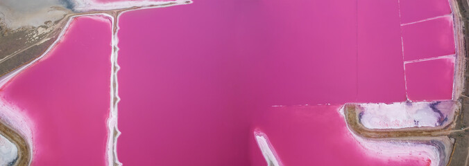 Pink lake top view. Aerial view of a pink lake with islands of salt protruding from the water. A popular place for tourists.