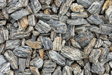 Crushed stone gray, light gray filling background close up
