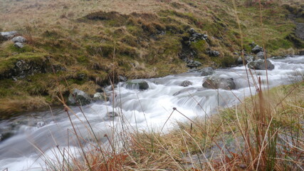 slow motion capture of a fast moving river in the mountains