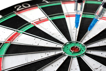 In the game of darts, the target in the middle is the vaccine in the syringe