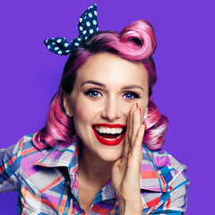 Beautiful happy excited woman holding hand near open mouth. Girl dressed in pin up. Blond model at...