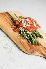 Fresh Cooked Asparagus with Sauce on Rustic Wooden Cutting Board