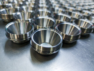 batch of shiny metal cnc aerospace parts production - close-up with selective focus for industrial...
