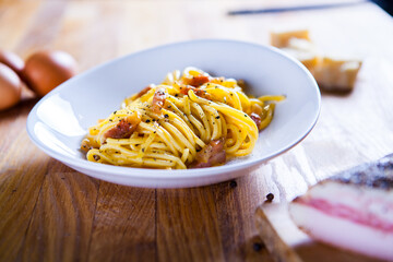 Spaghetti carbonara with egg  parmesan cheese and guanciale meat. Ingredients for fresh carbonara pasta. Spaghetti carbonara. Italian recipe. Fresh food. Macro Food Photography. Close Up