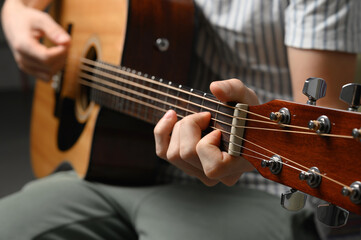 Fototapeta premium Man playing acoustic guitar, cover for online courses, learning at home.