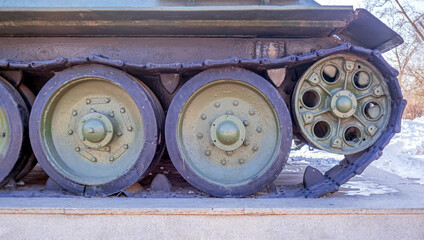 Crawlers of vintage military tank. Military equipment.