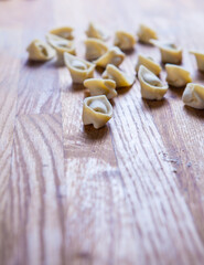 Fresh raw homemade tortellini or ravioli pasta. Arrangement of homemade italian Tortellini.  Freshly prepared homemade raw pasta recipe. Traditional Italian cuisine concept. Fresca Pasta in the pot