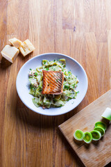 Pasta with roasted salmon in  sour cream leeks and dill. Fresh home made pasta. Delicious dish. beautifull fried salmon on top of home made pasta. Italian dish. Fine dining. Beautiful ingredients. 
