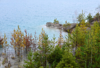 Chalk quarry artificial lakes in autumn season. Technogenic open pit is known as the Belarusian...