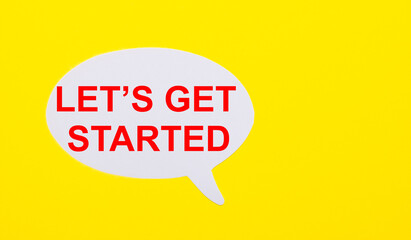 On a bright yellow background, white paper with the words LET IS GET STARTED