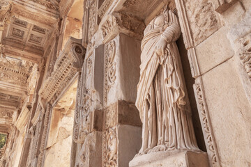 Celsus Library in Ephesus in Selcuk (Izmir), Turkey. Marble statue is Sophia, Goddess of Wisdom, at the Celcus Library at Ephesus, Turkey. The ruins of the ancient antique city.