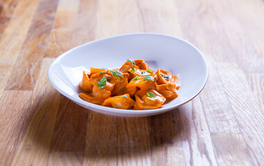 Delicious tortellini pasta in red tomato sauce with basil and parmesan cheese.
Tortellini pasta on white plare. Fine dish. Italian food
Home made fresh tortelini