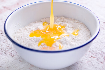 Making a shortcrust pastry adding melted butter to the flour