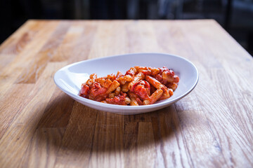 Rigatoni paste in tomato sauce with onion and vegetable. Red sos Penne pasta. Fresh food. Fres italian dish. Italian kitchen.